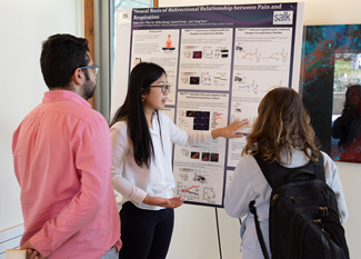 Scientist presenting a poster.